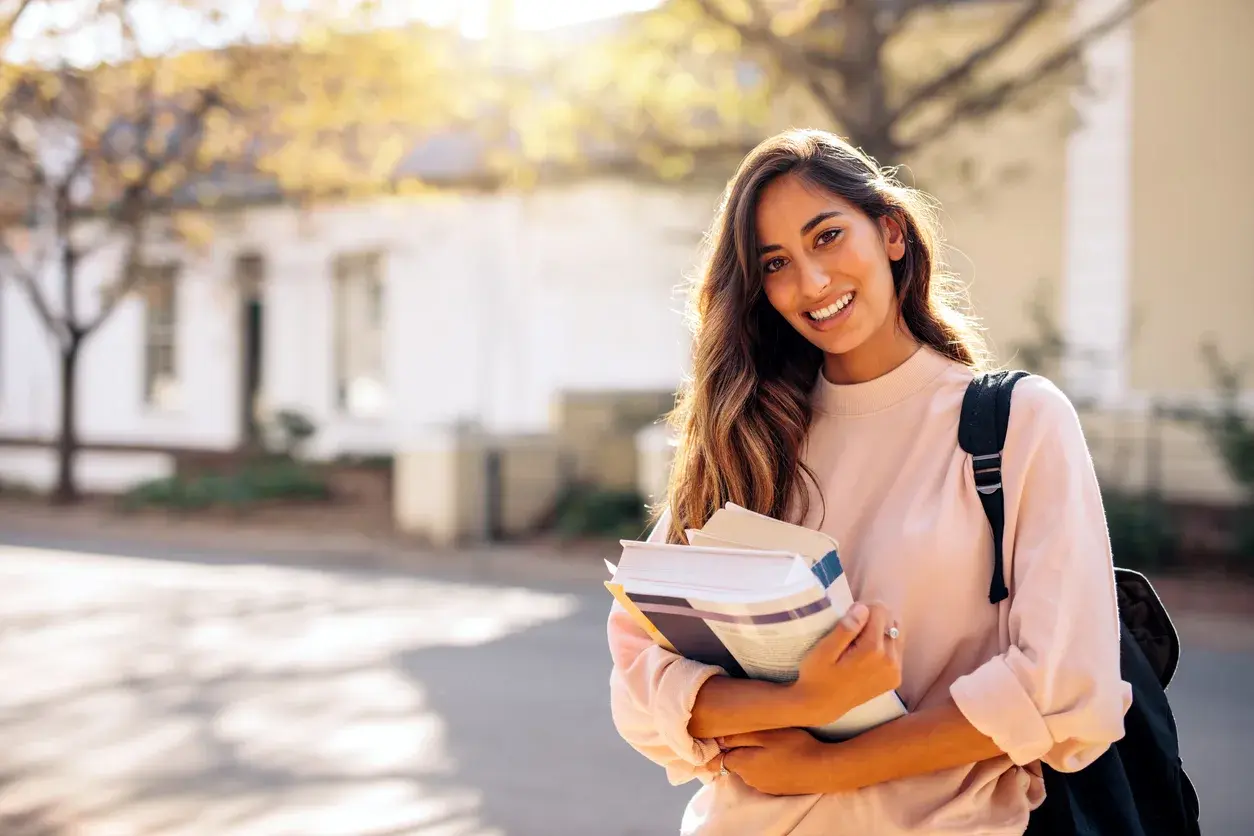 A student standing calmly outdoors